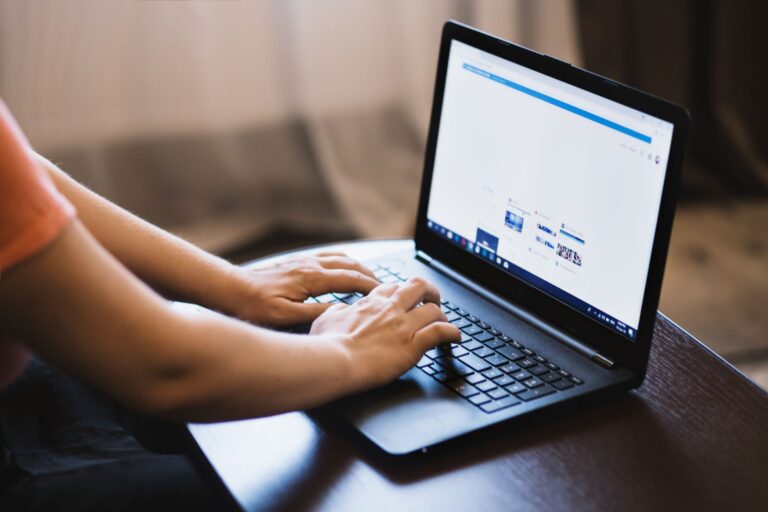 Person typing on a Windows laptop
