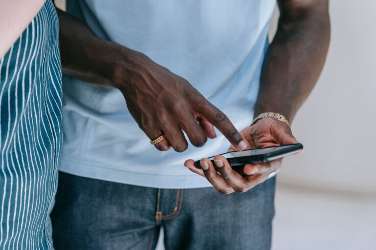 Person tapping an app on a smartphone